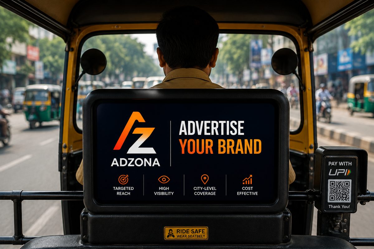 Adzona branded ad screen inside a Guntur auto-rickshaw, viewed from the back seat